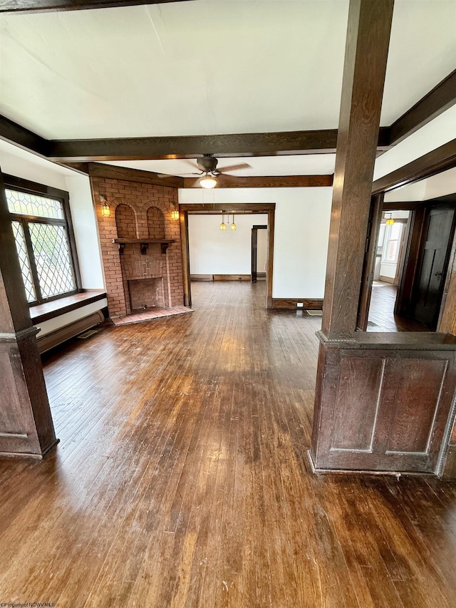108 Marshall St, Mannington, WV 26582 - unfurnished living room with hardwood / wood-style flooring, beam ceiling, ceiling fan, a brick fireplace, and baseboards