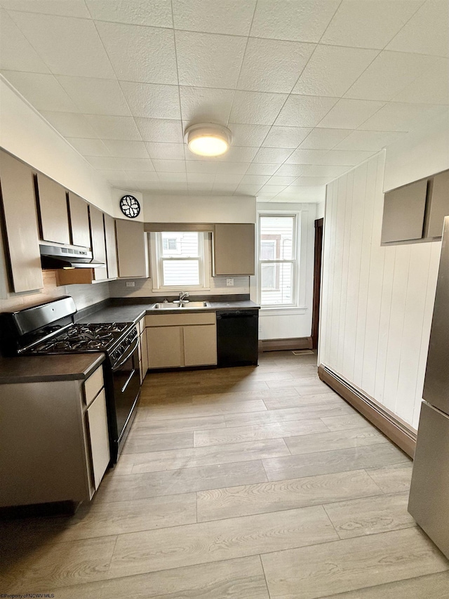108 Marshall St, Mannington, WV 26582 - kitchen featuring black appliances, dark countertops, light wood-type flooring, under cabinet range hood, and a sink