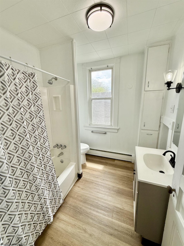 108 Marshall St, Mannington, WV 26582 - bathroom with a baseboard radiator, wood finished floors, vanity, shower / bathtub combination with curtain, and toilet