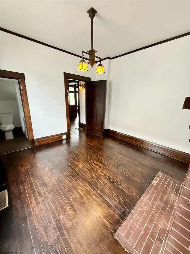 108 Marshall St, Mannington, WV 26582 - unfurnished dining area featuring ornamental molding, wood-type flooring, and baseboards
