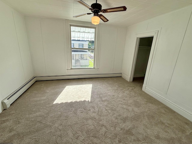 108 Marshall St, Mannington, WV 26582 - unfurnished bedroom with a decorative wall, carpet, baseboard heating, a walk in closet, and ceiling fan