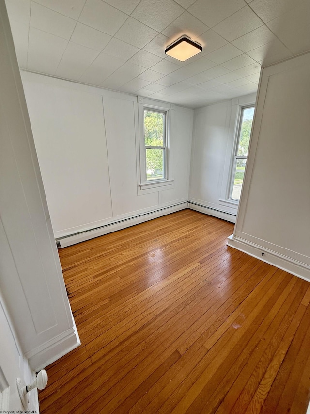 108 Marshall St, Mannington, WV 26582 - spare room featuring hardwood / wood-style floors and baseboard heating