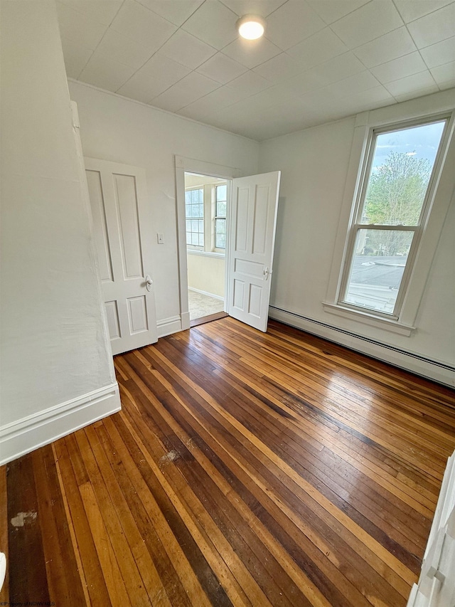 108 Marshall St, Mannington, WV 26582 - unfurnished bedroom with hardwood / wood-style flooring, a baseboard heating unit, and baseboards