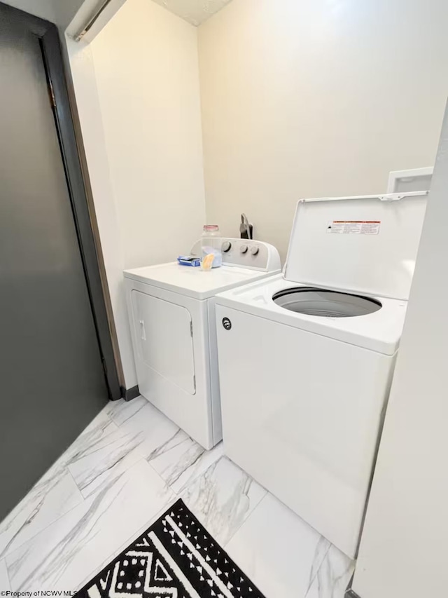 2081 Plum Run Rd, Mannington, WV 26582 - washroom with washing machine and clothes dryer and light marble finish flooring