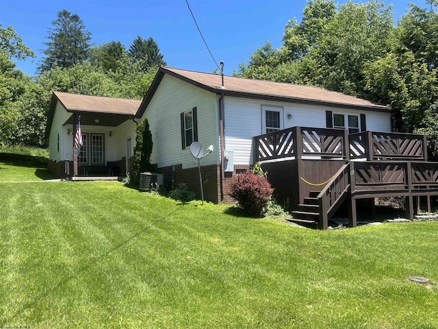 36 3rd St, Durbin, WV 26264 - back of property featuring a lawn, a wooden deck, and central AC