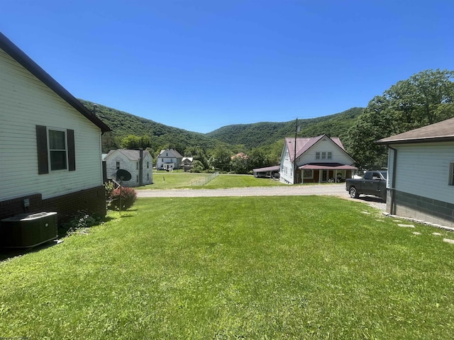 36 3rd St, Durbin, WV 26264 - view of grassy yard featuring central AC unit, a mountain view, and driveway