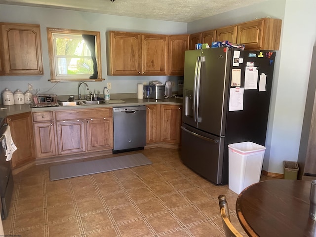 36 3rd St, Durbin, WV 26264 - kitchen with stainless steel appliances, a sink, brown cabinets, and a textured ceiling