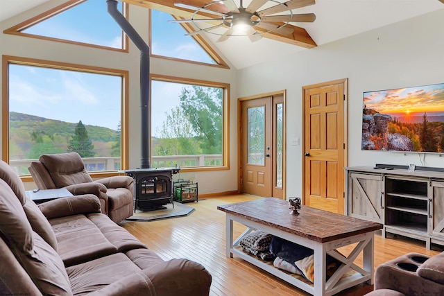 16 Cardinal Ln, Terra Alta, WV 26764 - living room featuring a wood stove, a ceiling fan, lofted ceiling, and light wood-type flooring