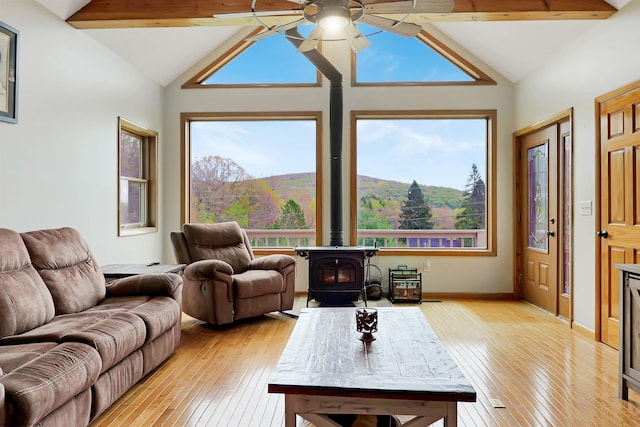 16 Cardinal Ln, Terra Alta, WV 26764 - living area featuring vaulted ceiling, a wood stove, light wood-type flooring, a ceiling fan, and a mountain view