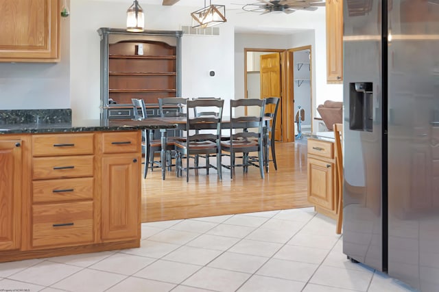 16 Cardinal Ln, Terra Alta, WV 26764 - kitchen with stainless steel fridge, ceiling fan, light wood finished floors, dark stone countertops, and pendant lighting