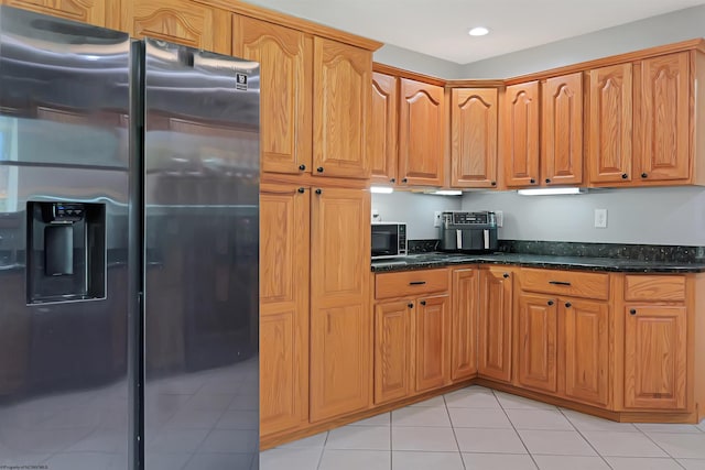 16 Cardinal Ln, Terra Alta, WV 26764 - kitchen featuring stainless steel fridge with ice dispenser, black microwave, light tile patterned floors, dark stone countertops, and brown cabinets