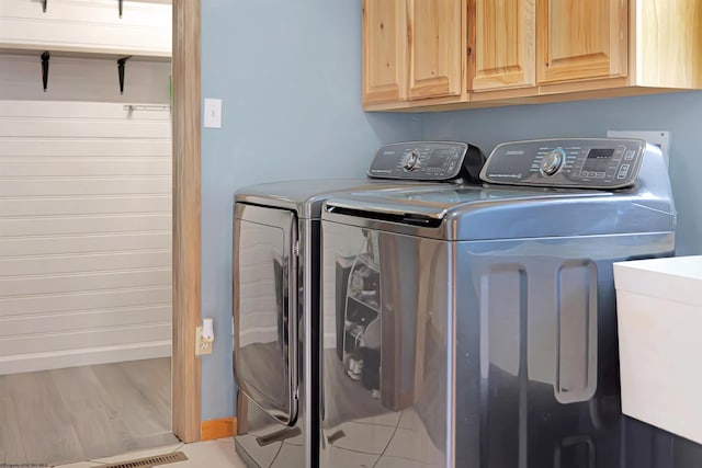 16 Cardinal Ln, Terra Alta, WV 26764 - laundry area featuring washer and clothes dryer, cabinet space, baseboards, and wood finished floors