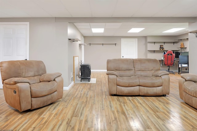 16 Cardinal Ln, Terra Alta, WV 26764 - living area with a wood stove, wood finished floors, a drop ceiling, and baseboards
