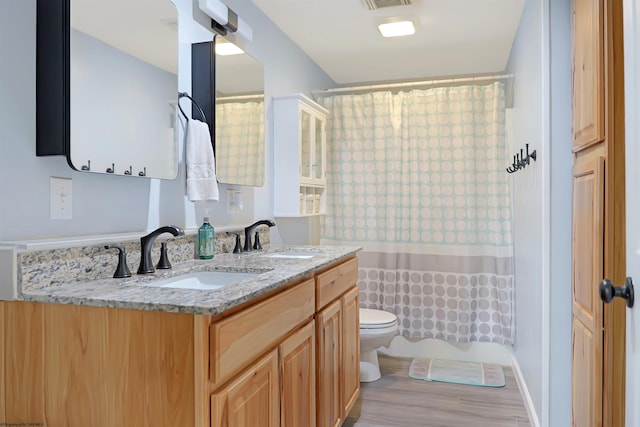 16 Cardinal Ln, Terra Alta, WV 26764 - bathroom featuring toilet, double vanity, wood finished floors, and curtained shower