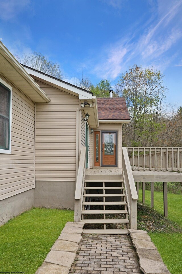 16 Cardinal Ln, Terra Alta, WV 26764 - view of exterior entry with a deck, a yard, and a shingled roof