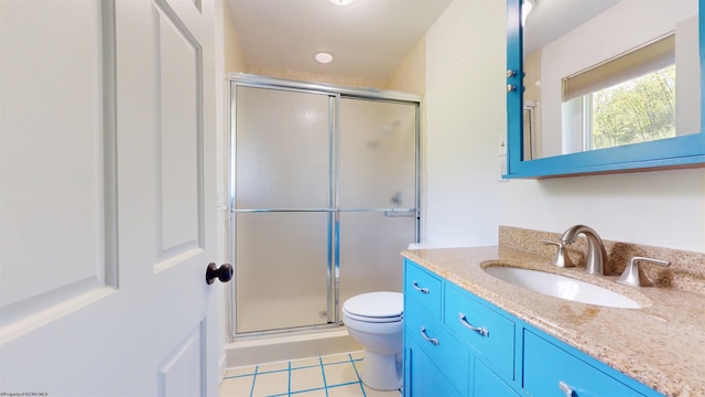 bathroom with a shower stall, toilet, tile patterned floors, and vanity