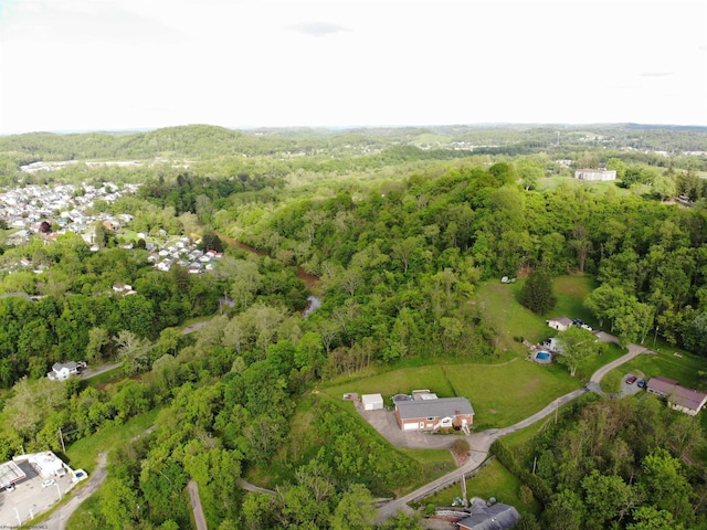aerial view of property's location featuring a forest