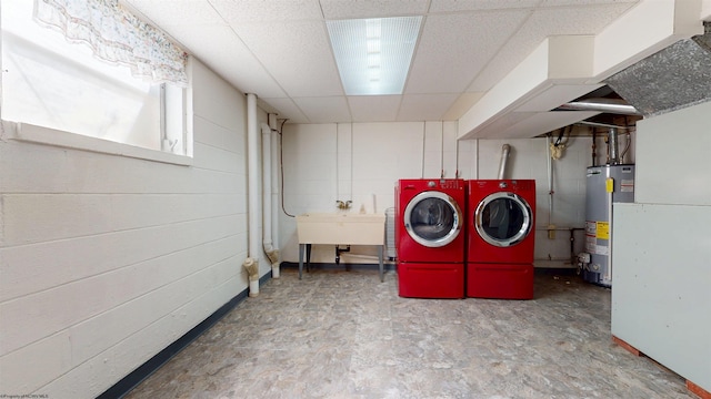 laundry room with separate washer and dryer, water heater, and a sink