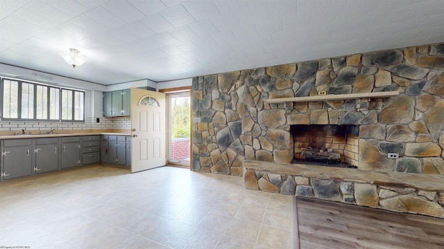 unfurnished living room featuring plenty of natural light and a fireplace