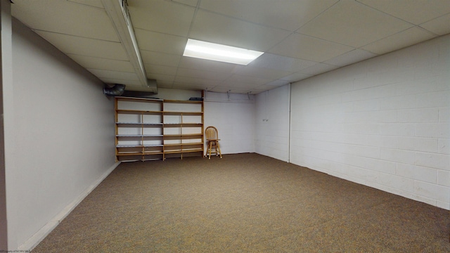 finished basement featuring carpet flooring and a drop ceiling