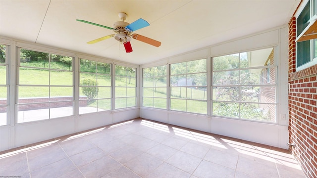 unfurnished sunroom with ceiling fan
