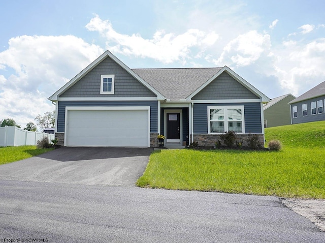craftsman house featuring stone siding, driveway, and an attached garage