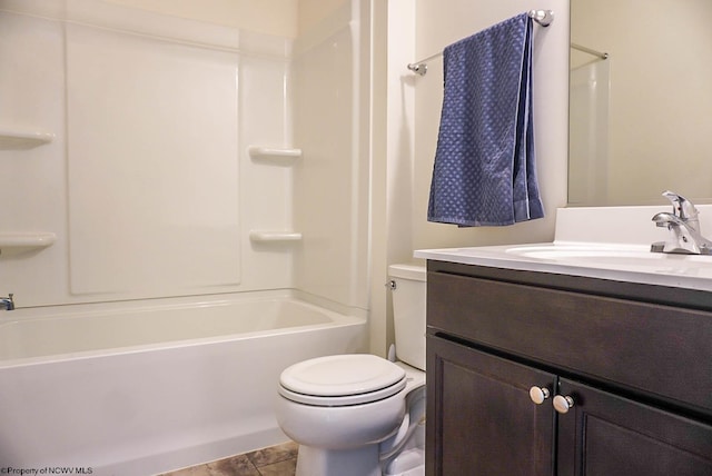 bathroom with toilet, vanity, and shower / bathtub combination