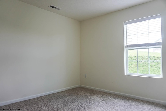 unfurnished room with light carpet and baseboards