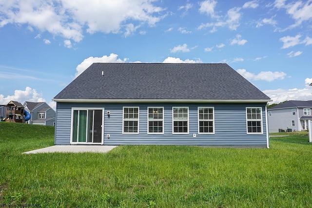 back of house featuring a lawn and a patio area