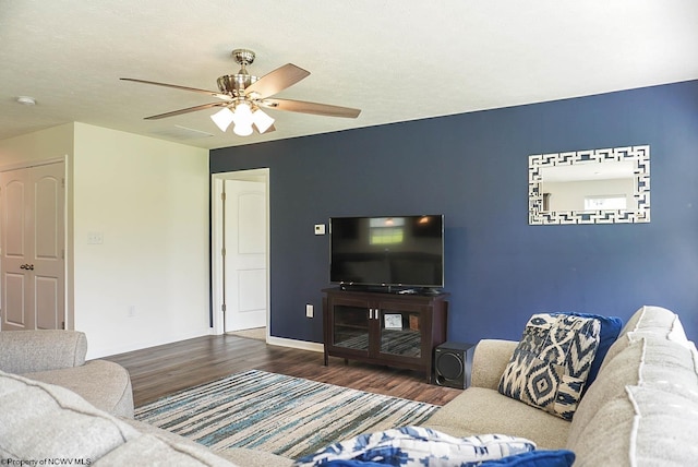 living area with wood finished floors, ceiling fan, and baseboards