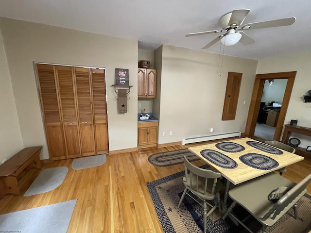 155 E St, Masontown, WV 26542 - dining room featuring a baseboard heating unit, light wood-style flooring, and ceiling fan