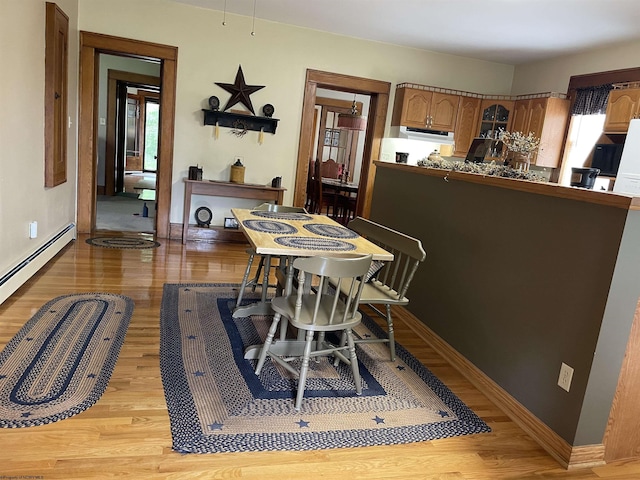 155 E St, Masontown, WV 26542 - dining area with light wood-type flooring, baseboards, and a baseboard radiator