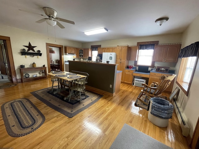 155 E St, Masontown, WV 26542 - dining area with a baseboard radiator, light wood-type flooring, a ceiling fan, and an AC wall unit