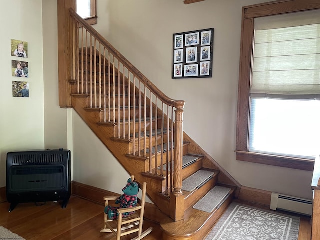 155 E St, Masontown, WV 26542 - stairs with a baseboard heating unit, wood finished floors, heating unit, and baseboards