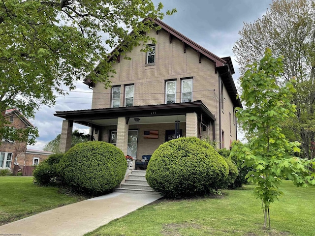 155 E St, Masontown, WV 26542 - view of front facade featuring brick siding, a front yard, and covered porch