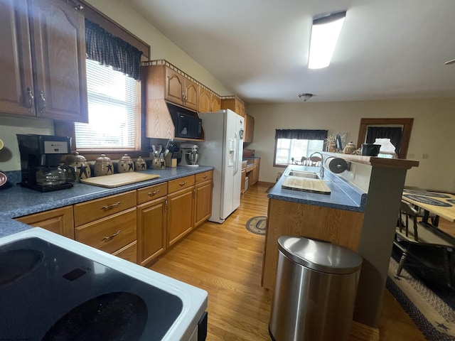 155 E St, Masontown, WV 26542 - kitchen featuring black microwave, white refrigerator with ice dispenser, range, a sink, and light wood-type flooring
