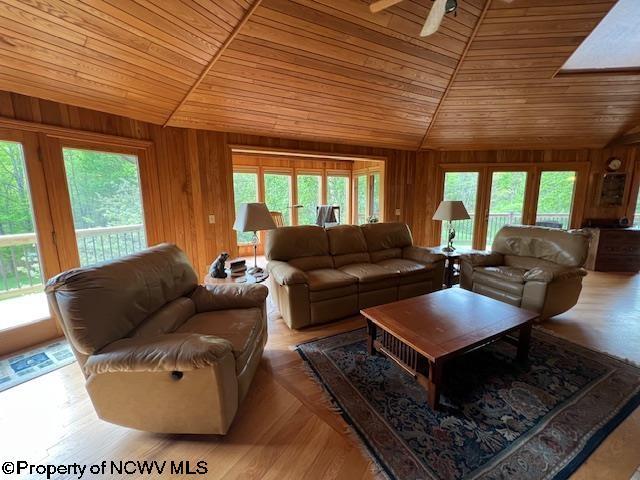 677 Dylan Rd, Elkins, WV 26241 - living area with lofted ceiling, wooden ceiling, wood walls, and ceiling fan