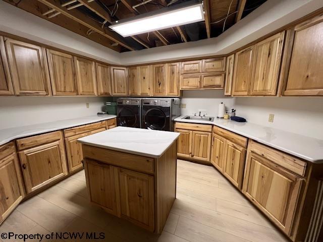 677 Dylan Rd, Elkins, WV 26241 - kitchen featuring washing machine and clothes dryer, a sink, a center island, and light countertops