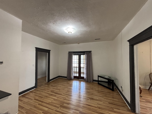 29 Dan St, Hepzibah, WV 26369 - spare room with french doors, wood finished floors, a textured ceiling, and baseboards