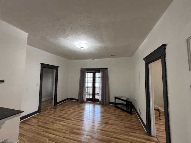 29 Dan St, Hepzibah, WV 26369 - spare room featuring wood finished floors, french doors, baseboards, and a textured ceiling
