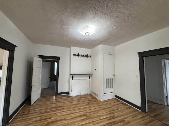 29 Dan St, Hepzibah, WV 26369 - unfurnished bedroom featuring wood finished floors, a textured ceiling, baseboards, and a closet