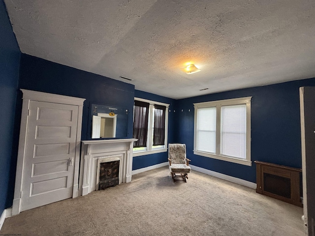 29 Dan St, Hepzibah, WV 26369 - unfurnished room with a textured ceiling, a fireplace, baseboards, and carpet floors