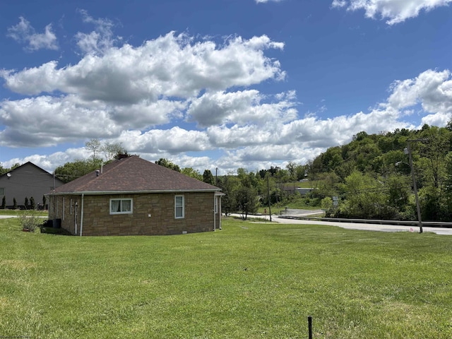 29 Dan St, Hepzibah, WV 26369 - view of side of property with stone siding, a yard, and roof with shingles