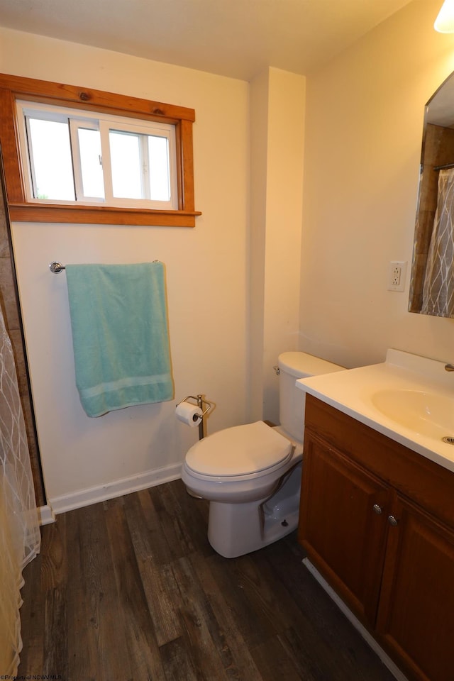full bath with wood finished floors, toilet, and vanity