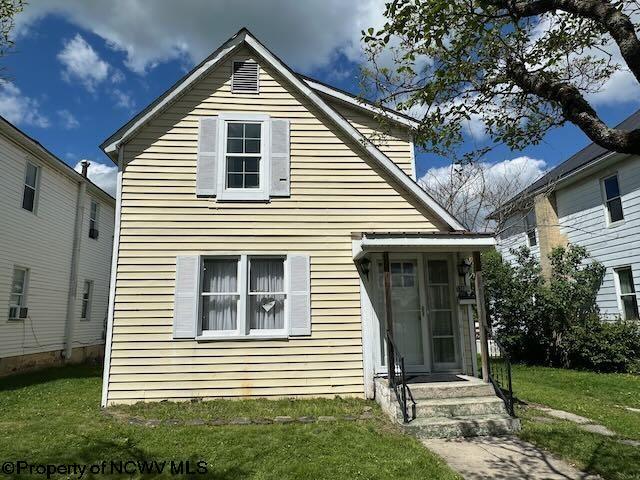 rear view of house with a lawn