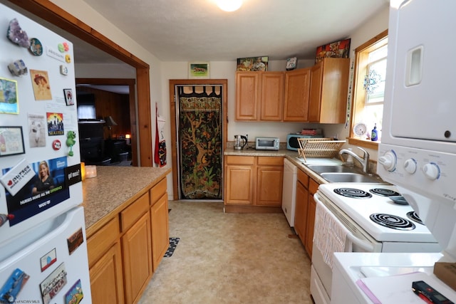 kitchen with white appliances, a sink, light flooring, and light countertops