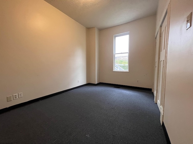 409 Forest Ave Unit 2, Morgantown, WV 26505 - empty room with dark colored carpet, baseboards, and a textured ceiling