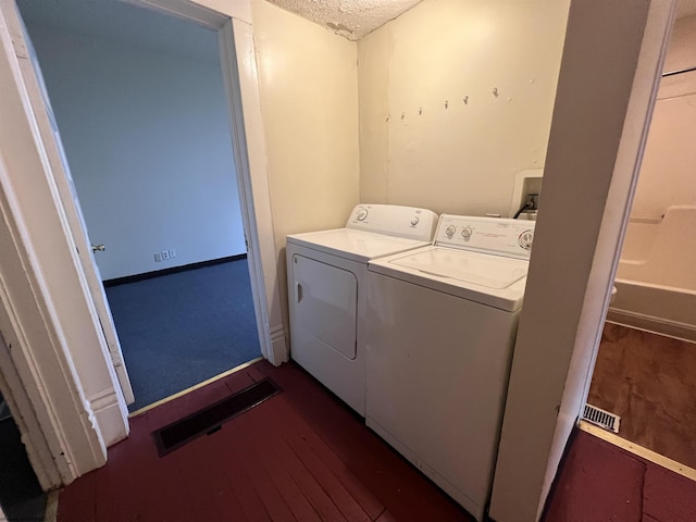 409 Forest Ave Unit 2, Morgantown, WV 26505 - laundry room featuring washing machine and clothes dryer, dark wood-style flooring, a textured ceiling, and baseboards