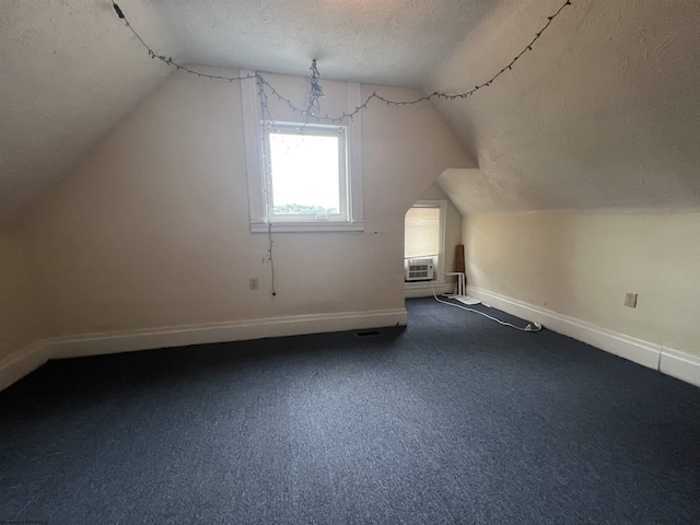 409 Forest Ave Unit 2, Morgantown, WV 26505 - additional living space with a textured ceiling, vaulted ceiling, baseboards, and dark carpet