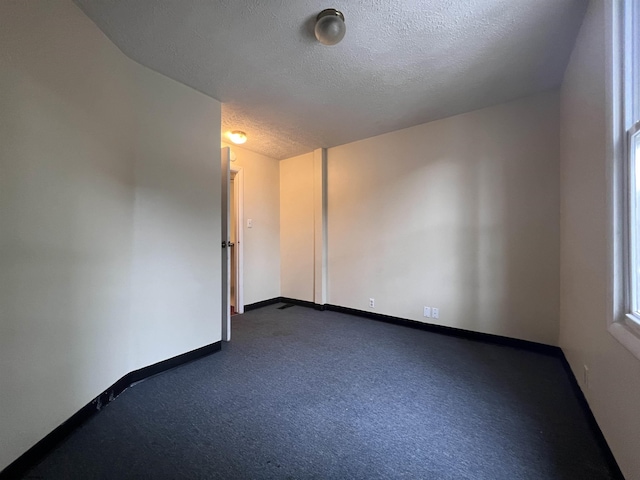 409 Forest Ave Unit 2, Morgantown, WV 26505 - unfurnished room with a textured ceiling, dark carpet, and baseboards